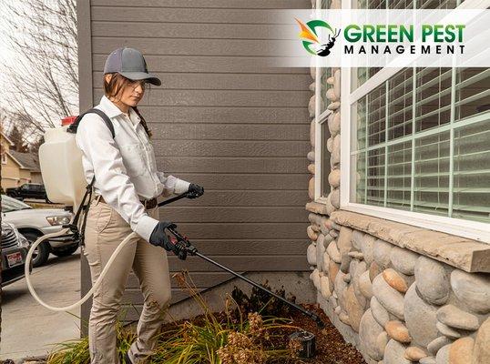 Green Pest Management pest control technician spraying for pests.