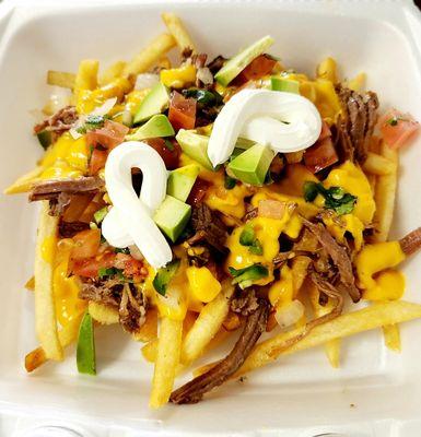 French fries topped with steak meat, nacho cheese, pico de gallo, avocado and sour cream