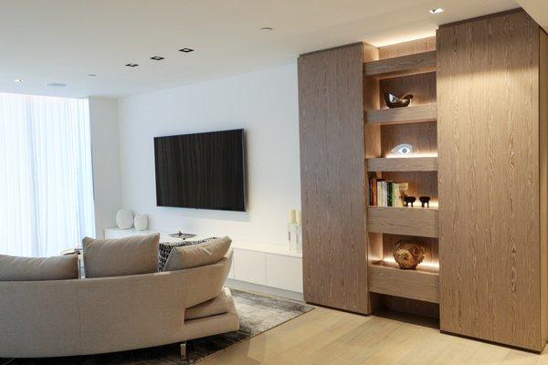 This Miami Beach apartment features Plank Silver Gray Oak paneling and White Satin finished cabinetry. Designed Carol Deane