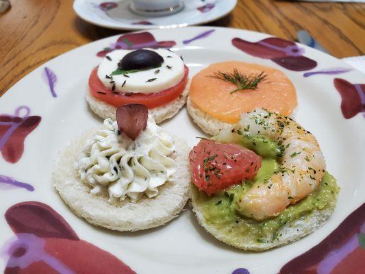 Tea sandwiches - angle #2: salmon, shrimp with avocado & grapefruit, goat cheese with grape, caprese