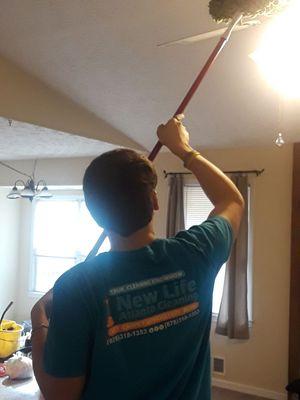 Dusting ceiling fan.