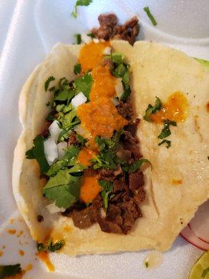 Carne asada taco with their red salsa, so good.