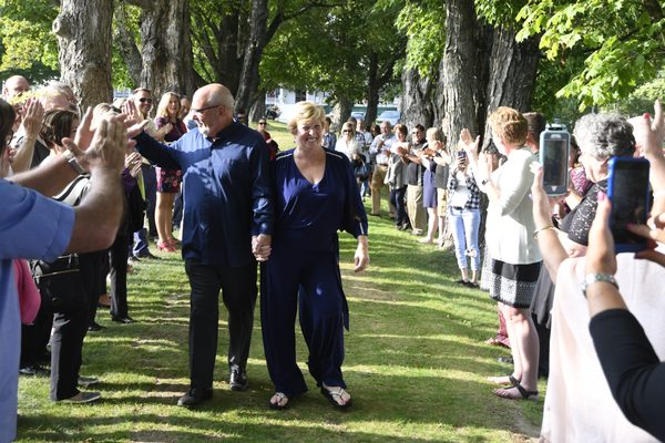 Family and friends celebrate couples 50th anniversary.