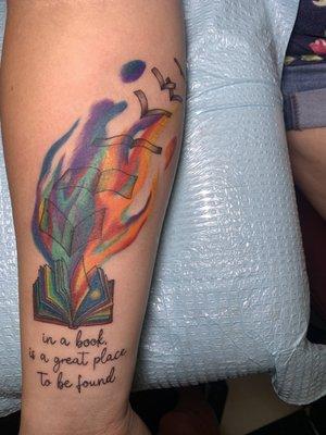 "In a book is a great place to be found" colorful book tattoo