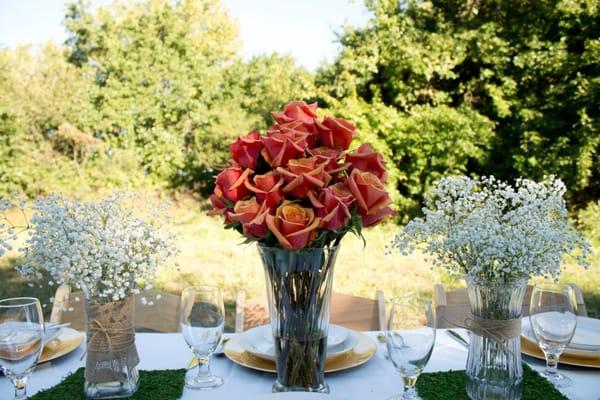 Rustic theme with bicolor roses and moss accented by delicate baby's breath.