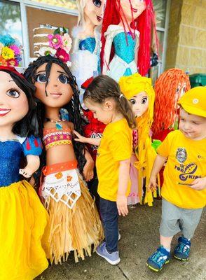 Little girl admiring Moana piñata