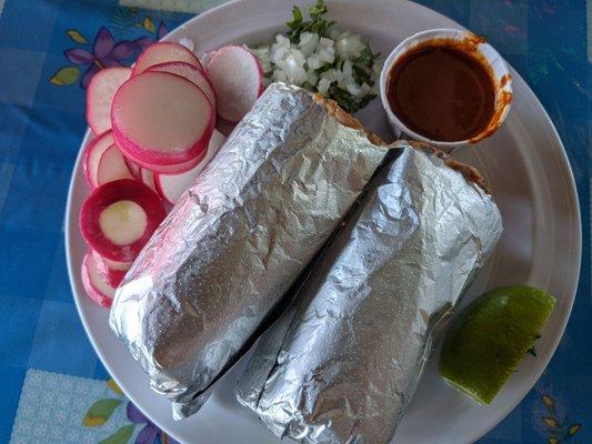 My carne asada burrito.  Radish slices, onions, cilantro, lime wedge and salsa were added by me to my plate from the salsa/condiment case.