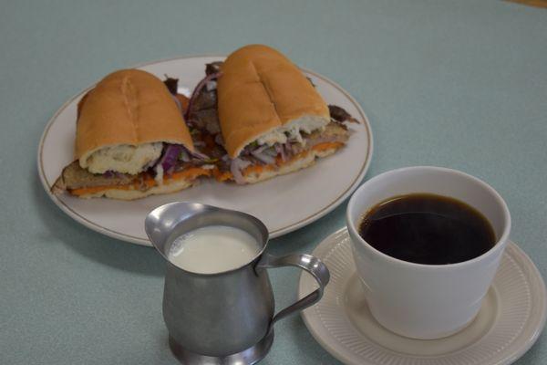 El Clasico Desayuno Peruano- Sandwich de Chicharron con su cafe con leche