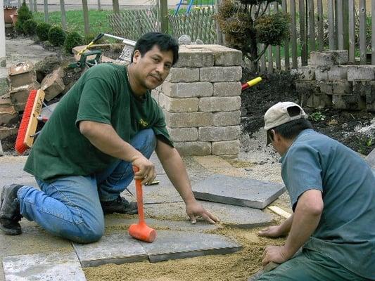 A few of Our crew members building an outdoor kitchen with a blue stone patio