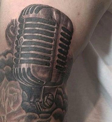 @kofek_ with the old school mic and custom clouds. Come in and get some black and grey work done by him today!