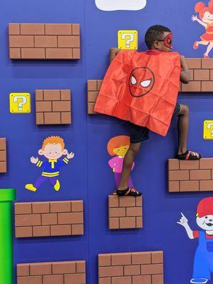 Spiderman climbing the rock wall