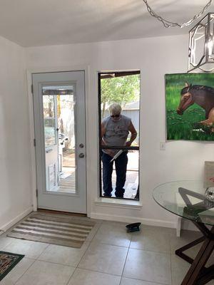 Steve caulking for the new window.