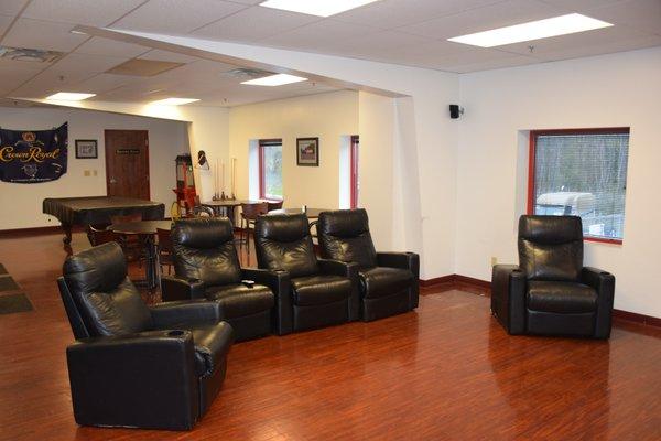 A comfortable lounge with theater seating and a large 82" television for your entertainment and comfort.