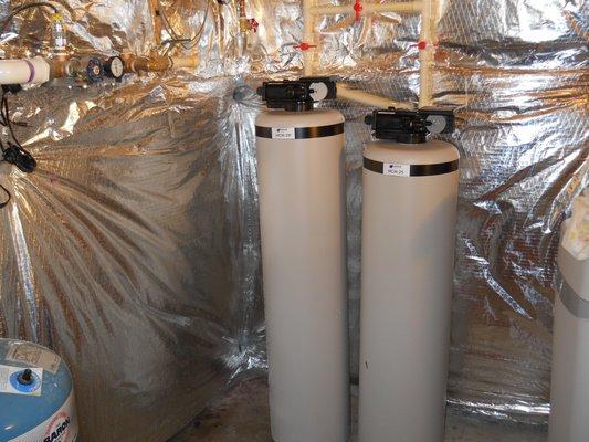 Water softener with calcium based acid neutralizer.