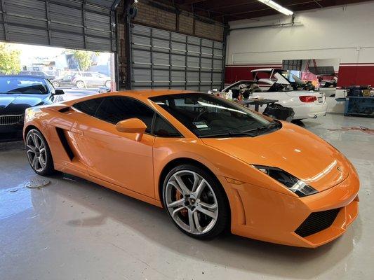 Lamborghini getting windows tinted and Ceramic Pro PPF