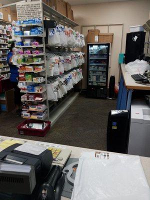 Behind the counter where all the filled prescriptions wait for pick up by customers