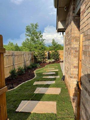 Complete backyard redo, fence, trees, shrubs, flowers, mulch, flagstone pavers and new sod.