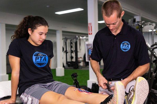 Physical Therapy Assistant Dylan Palmer performing manual therapy on patient.