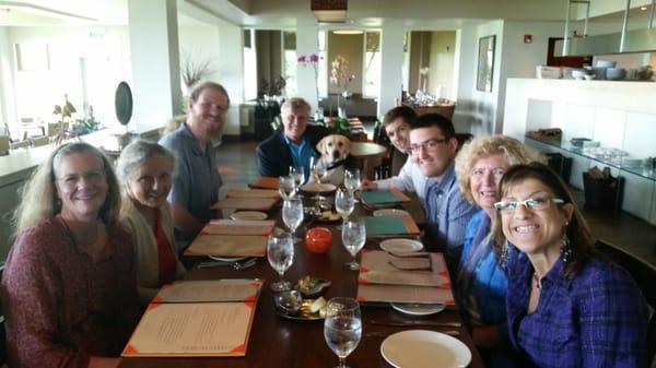 Here is our staff at an office lunch with guide dog in training Hannah. We raise guide dog puppies for their first year.