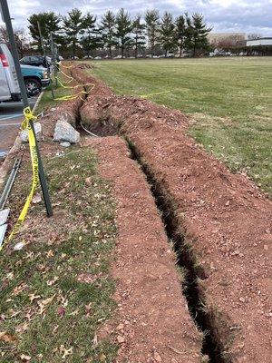 Trench for conduit to lamp bases