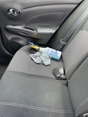 Dirty seats and cleaning supplies left inside car