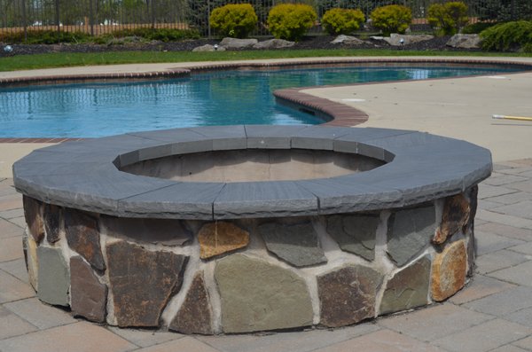 Fire pit repaired with blue stone capping.