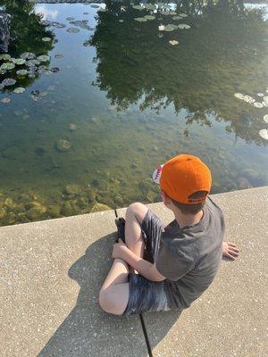 My son sitting near the pond near Maryland MSF, during group.