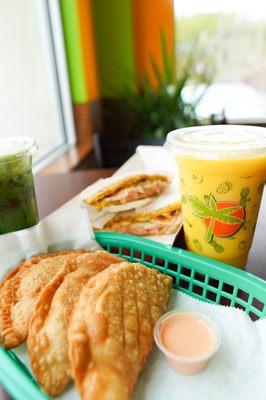 Fried empanadas, a smoothie and a patacon (made with fried plantains) in the back.