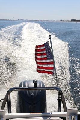 Love that American flag flying on the boat!!