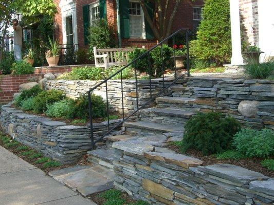 Stacked stone retaining walls and rebuilt steps