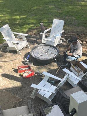 Installing a decorative outdoor fireplace.