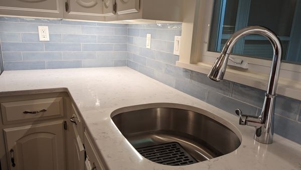 Quartz countertop by kitchen window. GranMarb did a beautiful job around the kitchen sink.