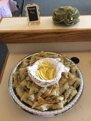 Miniature spanakopita goes d' oeuvres are a great way to have an eclectic array of food genres for you event