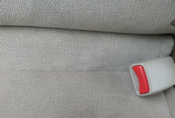 Fabric burn hole in car seat repaired