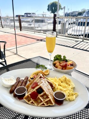 Waterfront Waffles, with a side of fruit.  (Two eggs any style and your choice of meat)