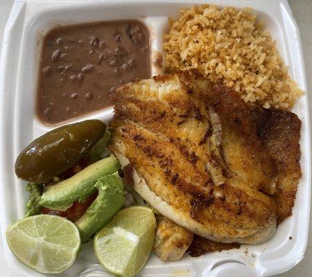 Platillo de pescada (Tilapia) with rice, beans, salad, and tortillas.