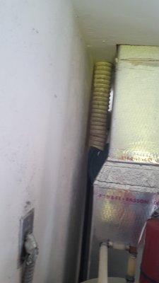 Damaged dryer vent hose NOT identified in inspection report. The report identified damage in the attic, not in the garage behind the A/C.