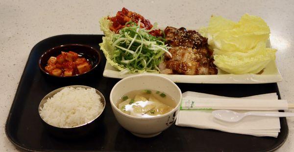 Bossam SueYouk - flavorful steamed pork belly. Served with radish kimchi, green onion salad, cabbage, diced radish kimchi, rice and soup