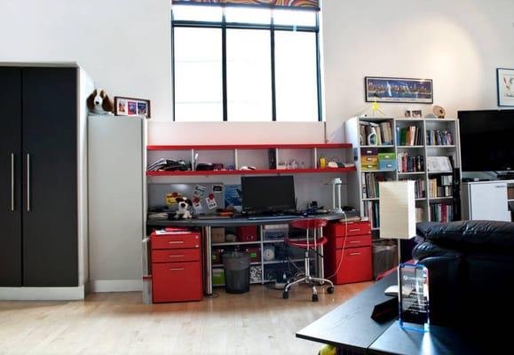 The kitchen seamlessly continues as bar (dark doors) book shelves, desk and more shelves.