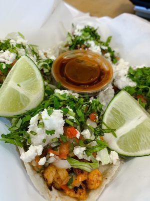 Chicken tacos! With lettuce, pico, queso fresco, and cilantro. With salsa and lime on the side.