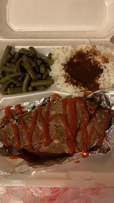 Dry meatloaf with ketchup rice and gravy green beans