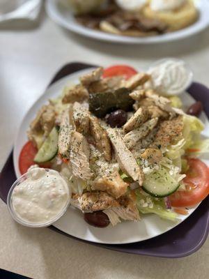 Greek chicken salad with tzatziki and grape leaves.