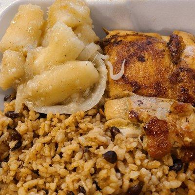 Close-up of grilled chicken with mixed rice and beans, and cassava with garlic and onion sauce. Simply delicious.