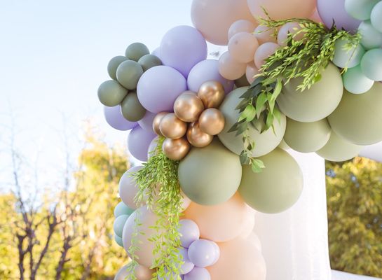 Add greenery or florals to your balloons