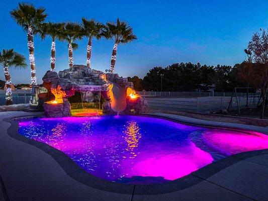 Beautiful freeform pool with custom grotto slide and a cave with the spa inside! #custompoolandspa