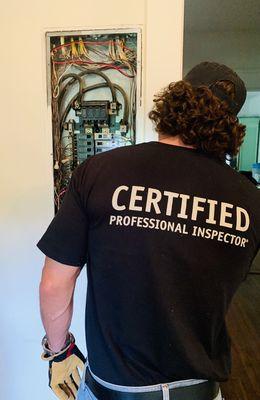 Licensed Professional Home Inspector, Wesley Smith, performing an inspection of the main electrical panel.