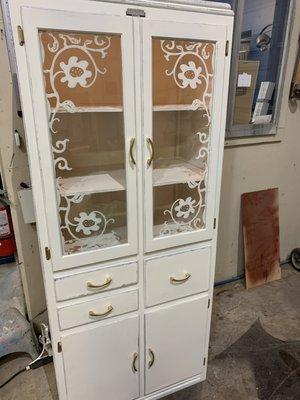 Refinished farmhouse cabinet with custom lighting.