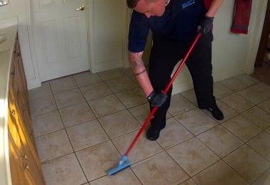 Scrubbing the grout during tile clean.