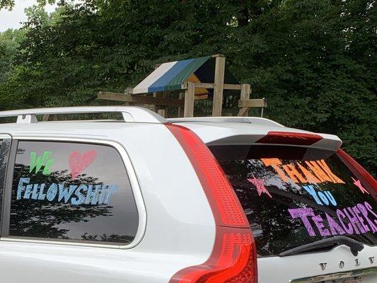 2020 graduates in decorated cars drive through the parking lot!