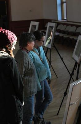 Visitors admire the work of Allison Heady at the first artist reception of the 2014 Old Brick Art Series